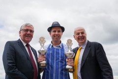 Grogan & Brown Artisan Butchers Tom Hayes TD (L) and Bobby Kerry (R) present the prestigious award to butcher and owner Jonathan Brown (missing Dermot Grogan)